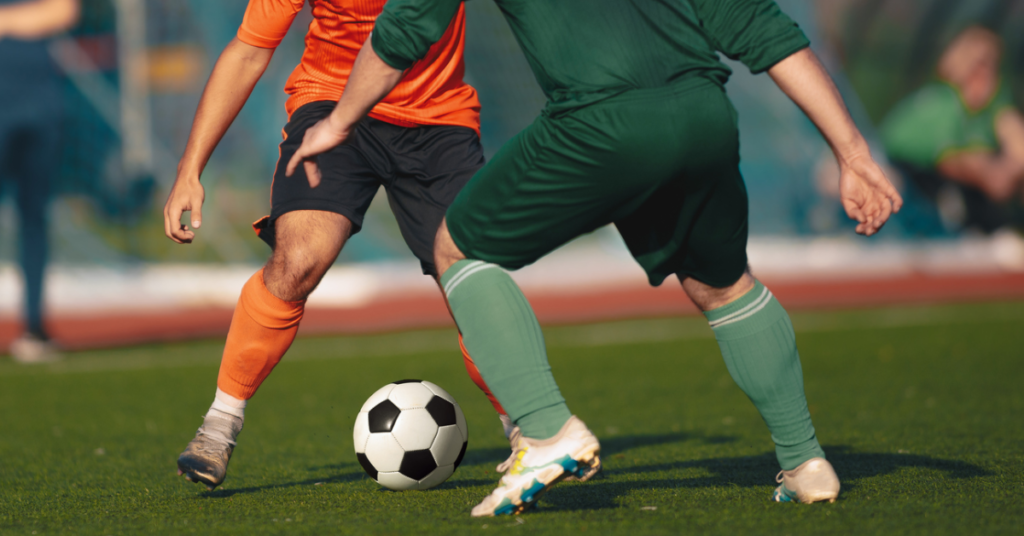 A photo of two people playing football.
